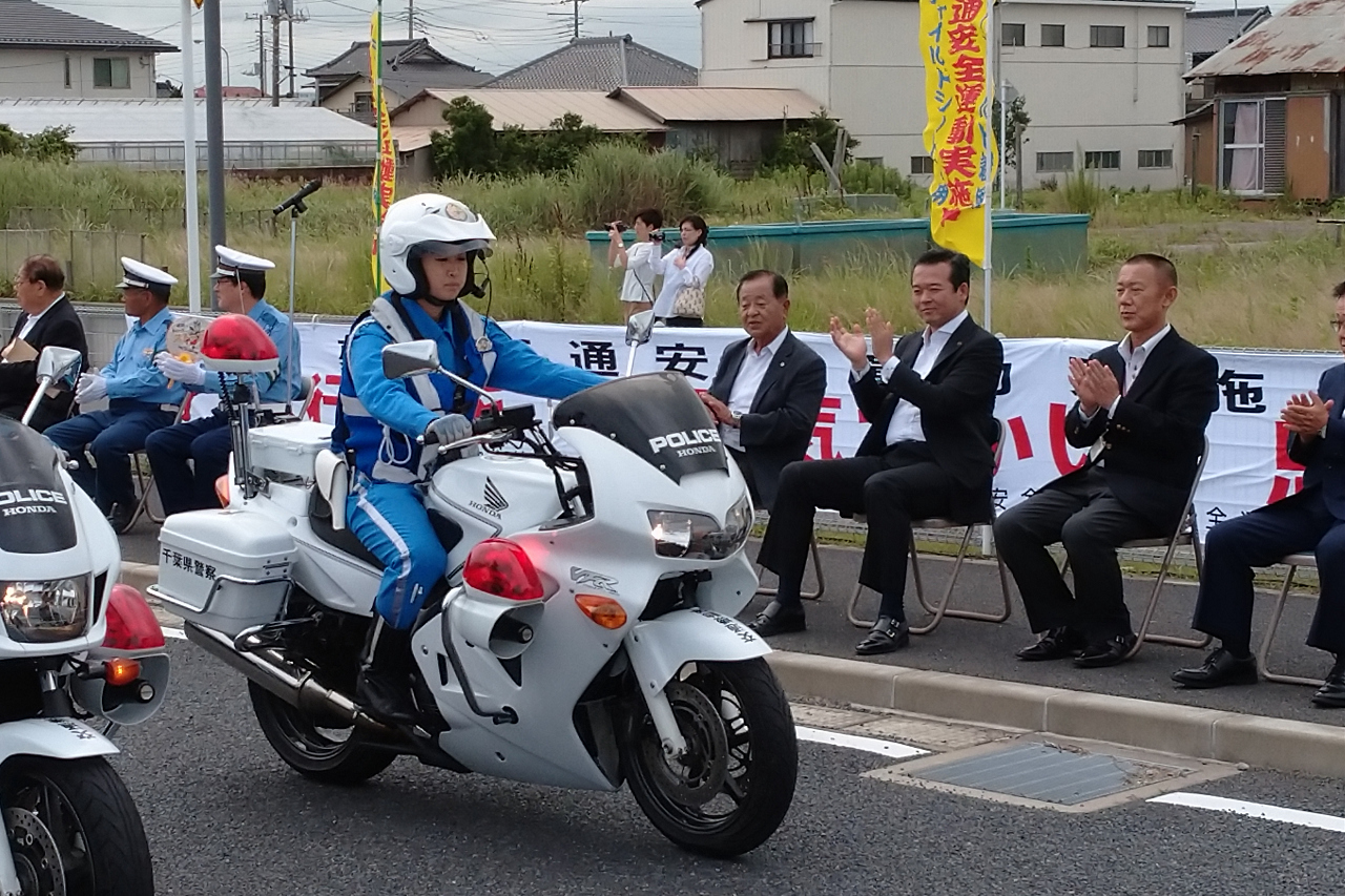 街頭パトロールに出発する警察車両を見送る市長　