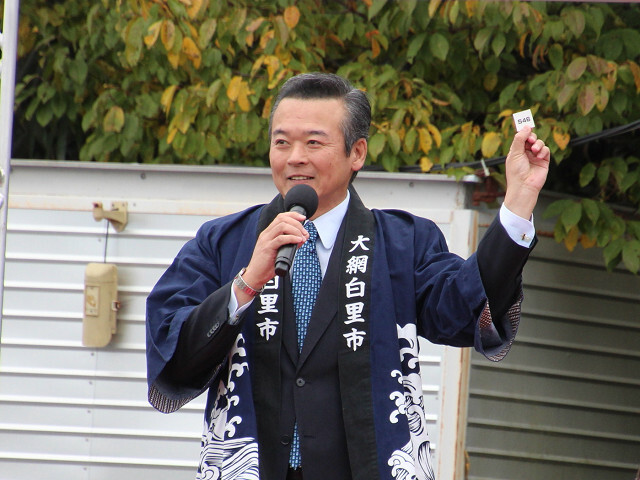 抽選会の当選番号を読み上げる市長の写真